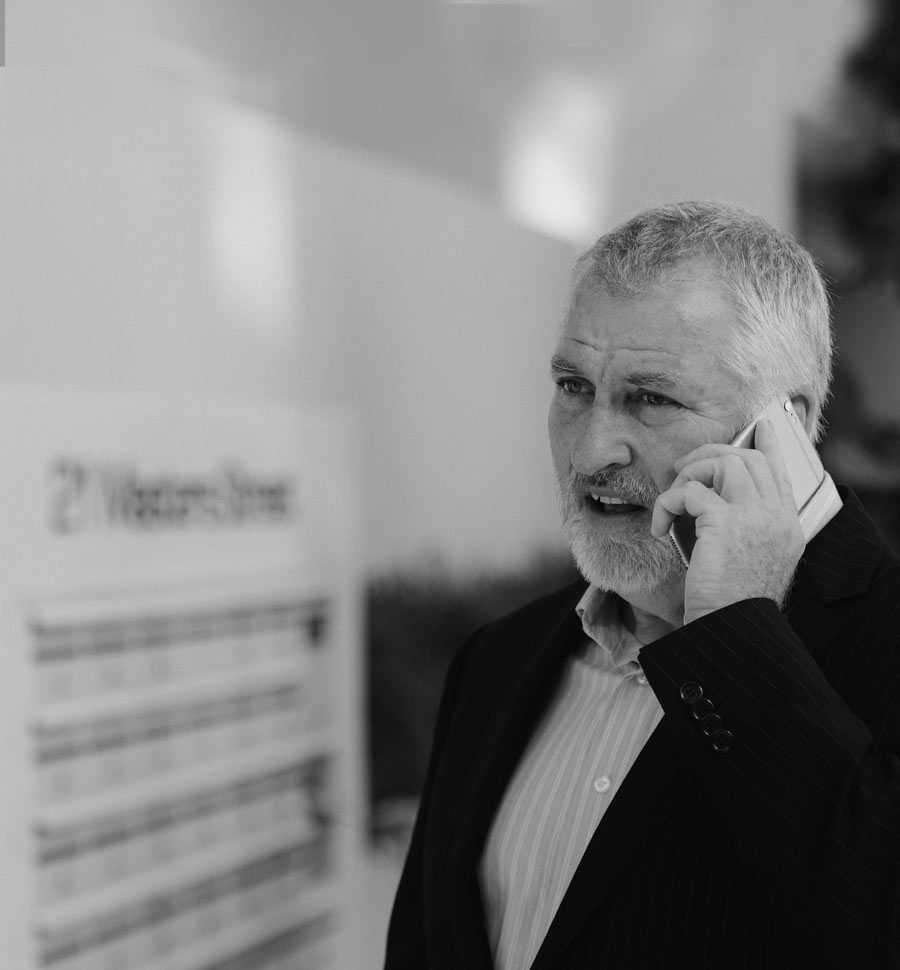 Photo of John Sage, property developer and investor, on the phone with a client